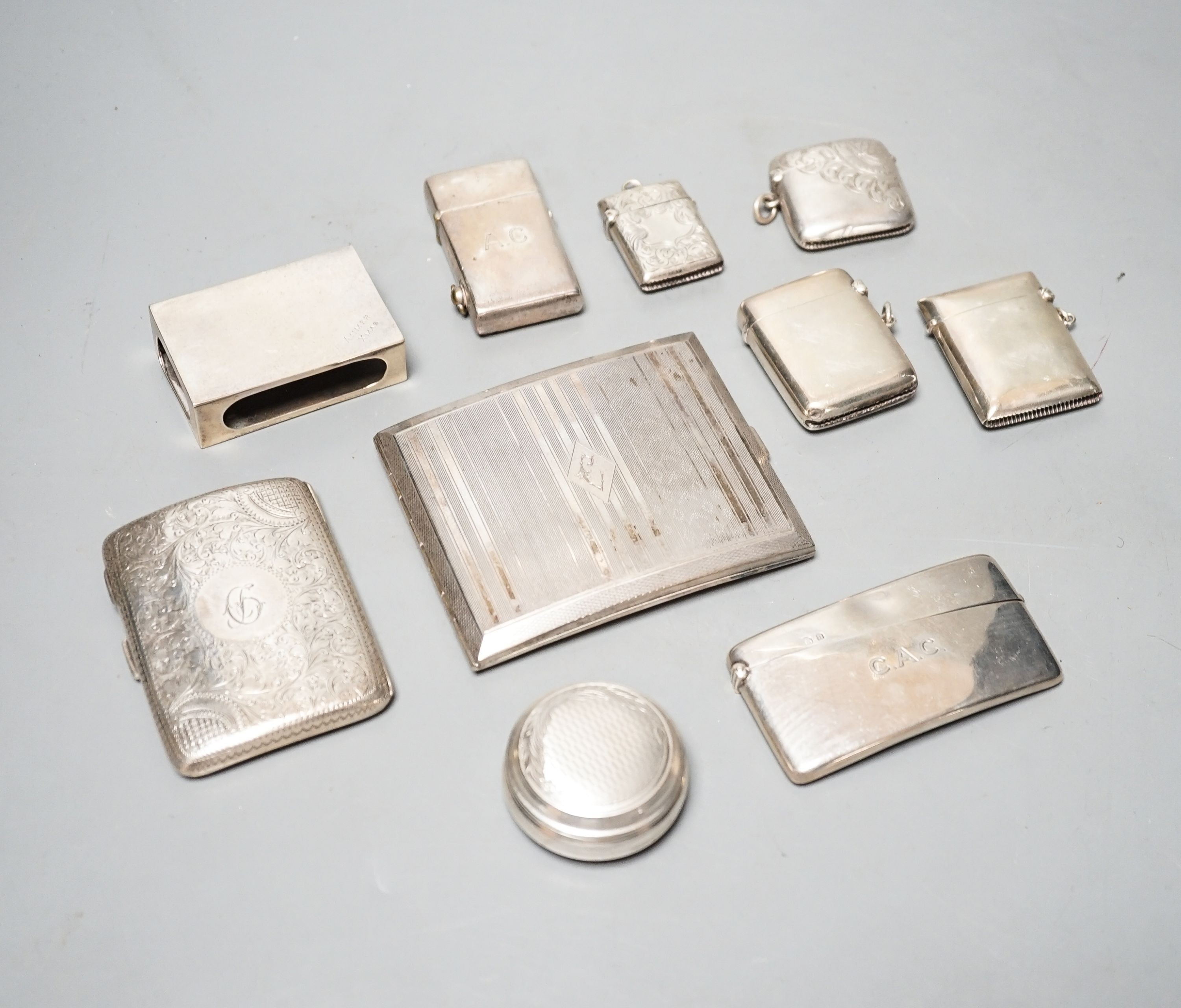 A group of assorted small silver to include four vesta cases, two cigarette cases (one plated), a card case, pill box, match sleeve and white metal mounted lighter.